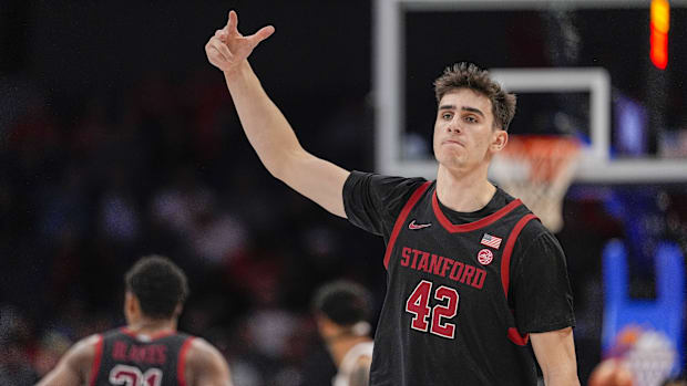 Stanford Cardinal forward Maxime Raynaud (42) celebrates after a dunk against the Louisville Cardinals.