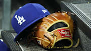 Apr 28, 2024; Toronto, Ontario, CAN; A hat and glove of an Los Angeles Dodgers player durng a game against the Toronto Blue Jays at Rogers Centre. Mandatory Credit: John E. Sokolowski-Imagn Images