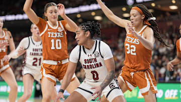 Mar 9, 2025; Greenville, SC, USA;South Carolina Gamecocks guard Te-Hina Paopao (0) moves on the court defended by Texas Longhorns guard Shay Holle (10) and guard Ndjakalenga Mwenentanda (32) during the second half at Bon Secours Wellness Arena. Mandatory Credit: Jim Dedmon-Imagn Images