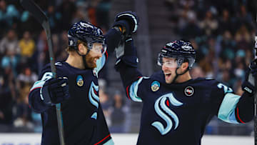 Jan 20, 2025; Seattle, Washington, USA; Seattle Kraken defenseman Adam Larsson (6) celebrates with defenseman Vince Dunn (29) after scoring a goal against the Buffalo Sabres during the third period at Climate Pledge Arena. Mandatory Credit: Joe Nicholson-Imagn Images