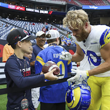 Aug 24, 2024; Houston, Texas, USA; Los Angeles Rams wide receiver Cooper Kupp (10) signs autographs before the game against the Houston Texans at NRG Stadium. Mandatory Credit: Troy Taormina-Imagn Images