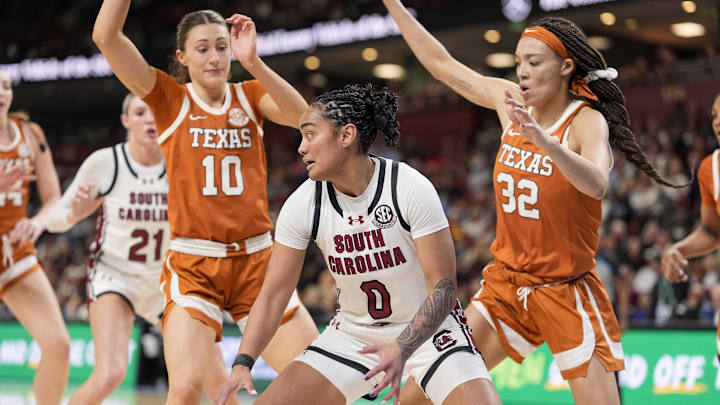 Mar 9, 2025; Greenville, SC, USA;South Carolina Gamecocks guard Te-Hina Paopao (0) moves on the court defended by Texas Longhorns guard Shay Holle (10) and guard Ndjakalenga Mwenentanda (32) during the second half at Bon Secours Wellness Arena. Mandatory Credit: Jim Dedmon-Imagn Images