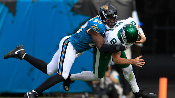 Jacksonville Jaguars linebacker Foyesade Oluokun (23) picks up a facemask penalty on New York Jets quarterback Aaron Rodgers (8) during the first quarter Sunday, Dec. 15, 2024 at EverBank Stadium in Jacksonville, Fla. [Corey Perrine/Florida Times-Union]