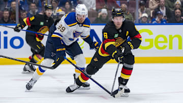 Dec 10, 2024; Vancouver, British Columbia, CAN; St. Louis Blues forward Pavel Buchnevich (89) stick checks Vancouver Canucks forward Brock Boeser (6) during the second period at Rogers Arena. Mandatory Credit: Bob Frid-Imagn Images