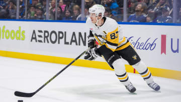 Feb 27, 2024; Vancouver, British Columbia, CAN; Pittsburgh Penguins forward Sidney Crosby (87) handles the puck against the Vancouver Canucks in the third period at Rogers Arena. Penguins won 4-3 in overtime. Mandatory Credit: Bob Frid-USA TODAY Sports
