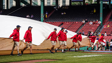 Jun 14, 2023; Boston, Massachusetts, USA; The Boston Red Sox field crew cover the field in