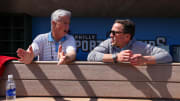 Feb 25, 2024; Clearwater, Florida, USA;  Philadelphia Phillies president of baseball operations Dave Dombrowski and general manager Sam Fuld talk in the dugout before a game against the New York Yankees at BayCare Ballpark. 