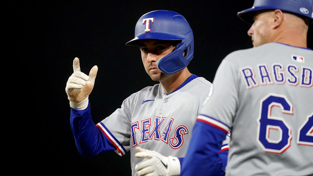 Apr 23, 2025; West Sacramento, California, USA; Texas Rangers catcher Kyle Higashioka (11) points toward the dugout after hitting a single against the Athletics in the fifth inning at Sutter Health Park. 
