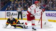 Oct 28, 2024; Vancouver, British Columbia, CAN; Carolina Hurricanes forward Sebastian Aho (20) scores the game winning goal on Vancouver Canucks goalie Kevin Lankinen (32) in overtime at Rogers Arena. Mandatory Credit: Bob Frid-Imagn Images
