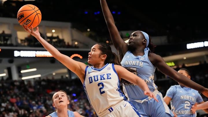 Mar 28, 2025; Birmingham, AL, USA; Duke Blue Devils guard Vanessa de Jesus (2) slips past North Carolina Tar Heels center Maria Gakdeng (5) for two points at Legacy Arena in the Sweet 16. Mar 28, 2025; Birmingham, AL, USA; Duke Blue Devils guard Vanessa de Jesus (2) slips past North Carolina Tar Heels center Maria Gakdeng (5) for two points at Legacy Arena in the Sweet 16.