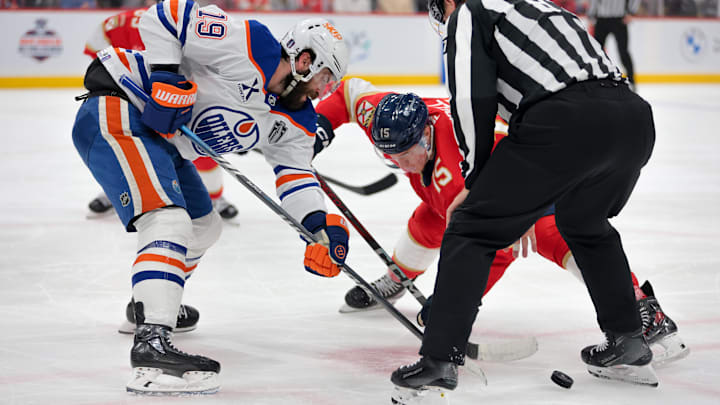 Jun 17, 2025; Sunrise, Florida, USA; Edmonton Oilers center Adam Henrique (19) faces off against Florida Panthers center Anton Lundell (15) during the second period in game six of the 2025 Stanley Cup Final at Amerant Bank Arena. Mandatory Credit: Sam Navarro-Imagn Images