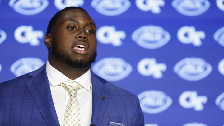 Zeek Biggers speaking at the podium at ACC Media Day. 