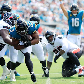 Jacksonville Jaguars running back Bhayshul Tuten (33) scores a rushing touchdown as quarterback Trevor Lawrence (16) celebrates during the first quarter of an NFL football matchup at EverBank Stadium, Sunday, Sept. 21, 2025, in Jacksonville, Fla. The Jaguars defeated the Texans 17-10. The Jaguars defeated the Texans 17-10.