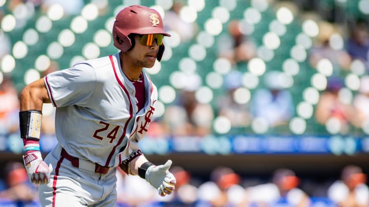 May 24, 2024; Charlotte, NC, USA; Florida State Seminoles infielder Cam Smith (24) runs to first on a double against the Virginia Cavaliers in the fourth inning during the ACC Baseball Tournament at Truist Field. 