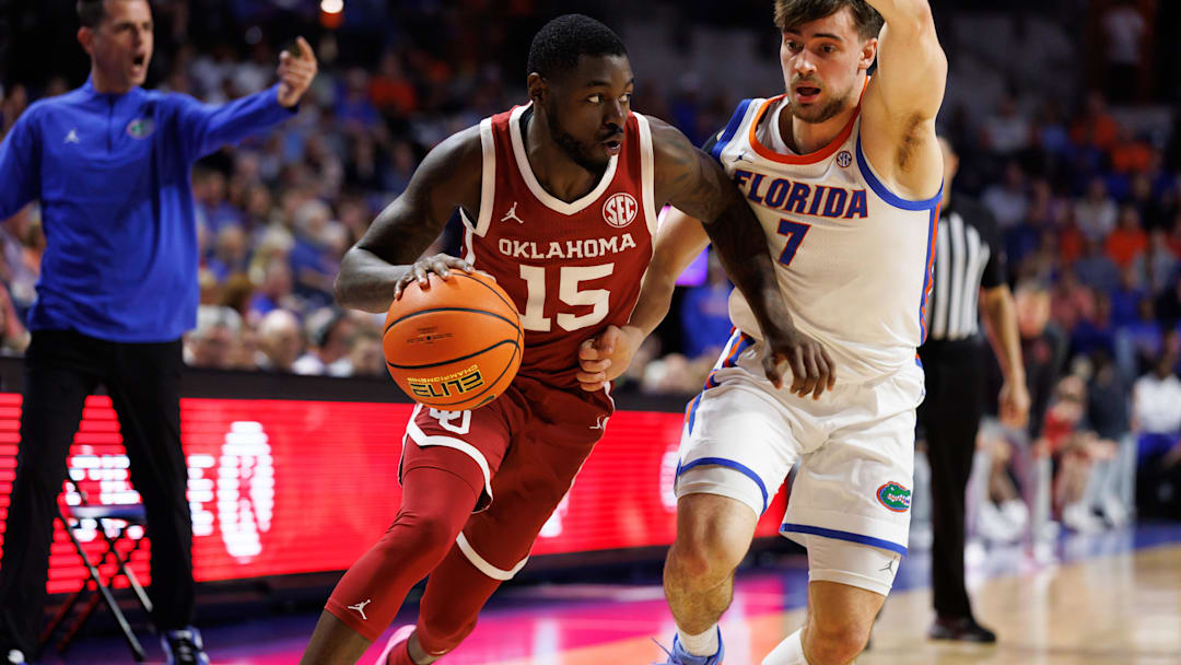 Feb 18, 2025; Gainesville, Florida, USA; Oklahoma Sooners guard Duke Miles (15) drives past Florida Gators guard Urban Klavzar (7) during the first half at Exactech Arena at the Stephen C. O'Connell Center. Mandatory Credit: Matt Pendleton-Imagn Images