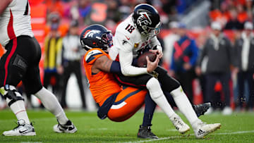 Nov 17, 2024; Denver, Colorado, USA; Denver Broncos linebacker Nik Bonitto (15) sacks Atlanta Falcons quarterback Kirk Cousins (18) in the second half at Empower Field at Mile High. Mandatory Credit: Ron Chenoy-Imagn Images