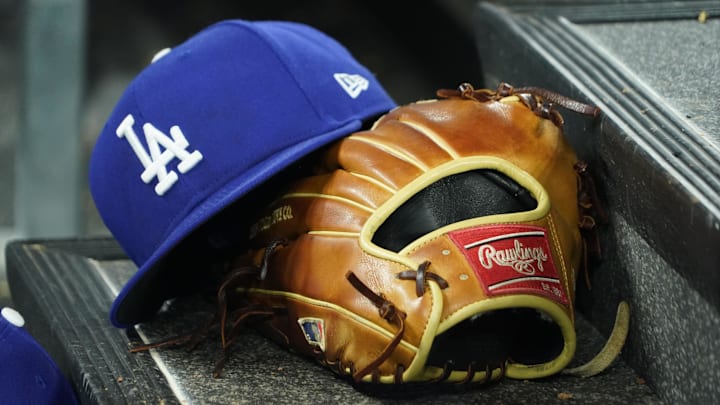 Apr 28, 2024; Toronto, Ontario, CAN; A hat and glove of an Los Angeles Dodgers player durng a game against the Toronto Blue Jays at Rogers Centre. Mandatory Credit: John E. Sokolowski-Imagn Images Apr 28, 2024; Toronto, Ontario, CAN; A hat and glove of an Los Angeles Dodgers player durng a game against the Toronto Blue Jays at Rogers Centre. Mandatory Credit: John E. Sokolowski-Imagn Images