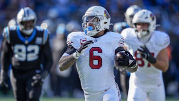 Dec 22, 2024; Charlotte, North Carolina, USA; Arizona Cardinals running back James Conner (6) runs for yardage against the Carolina Panthers during the second quarter at Bank of America Stadium. Mandatory Credit: Jim Dedmon-Imagn Images