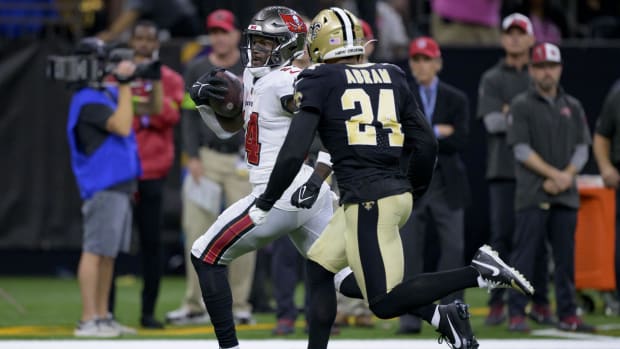 Tampa Bay Buccaneers receiver Chris Godwin (14) runs past New Orleans Saints safety Johnathan Abram (24) after a reception 