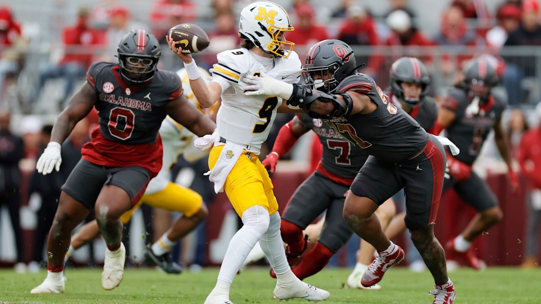 Missouri Tigers quarterback Beau Pribula (9) avoids a sack in a game versus the Oklahoma Sooners this season.