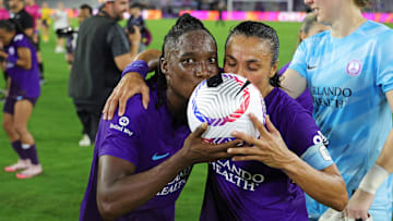 Orlando Pride forward Barbra Banda (22) and Orlando Pride forward Marta (10) kiss the game ball after the win against Utah Royals F 