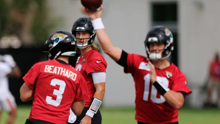 Jacksonville Jaguars quarterback Trevor Lawrence (16) looks on as quarterback Mac Jones (10) passes next to quarterback C.J. Beathard (3) during a combined NFL football training camp session between the Tampa Bay Buccaneers and Jacksonville Jaguars Thursday, Aug. 15, 2024 at EverBank Stadium’s Miller Electric Center in Jacksonville, Fla.