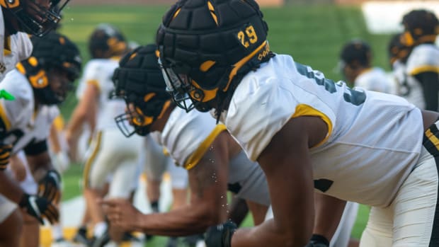 Defensive linemen for the Missouri Tigers prepare to clash with the offensive linemen during warm ups.