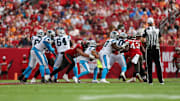 Dec 29, 2024; Tampa, Florida, USA; Tampa Bay Buccaneers defensive end Logan Hall (90) sacks Carolina Panthers quarterback Bryce Young (9) in the fourth quarter at Raymond James Stadium. Mandatory Credit: Nathan Ray Seebeck-Imagn Images