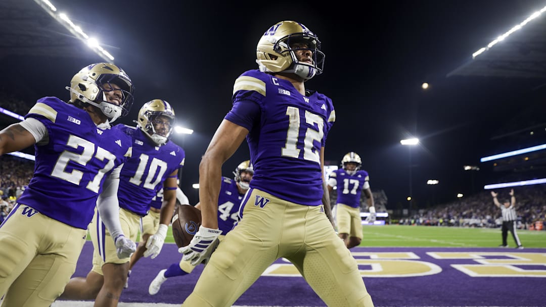 Sep 6, 2025; Seattle, Washington, USA; Washington Huskies wide receiver Denzel Boston (12) celebrates after returning a punt for a touchdown against the UC Davis Aggies during the second quarter at Husky Stadium. Washington Huskies safety Vincent Holmes (27) and linebacker Xe'ree Alexander (10) follow behind Boston. Mandatory Credit: Joe Nicholson-Imagn Images