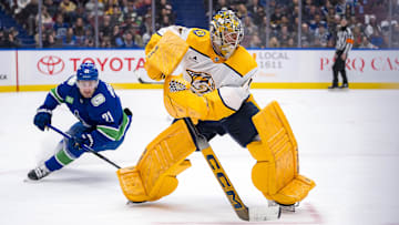 Jan 3, 2025; Vancouver, British Columbia, CAN; Vancouver Canucks forward Nils Hoglander (21) watches Nashville Predators goalie Juuse Saros (74) handle the puck in the second period at Rogers Arena. Mandatory Credit: Bob Frid-Imagn Images