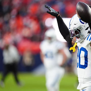 Dec 15, 2024; Denver, Colorado, USA; Indianapolis Colts safety Nick Cross (20) celebrates his interception in the second half against the Denver Broncos at Empower Field at Mile High. Mandatory Credit: Ron Chenoy-Imagn Images