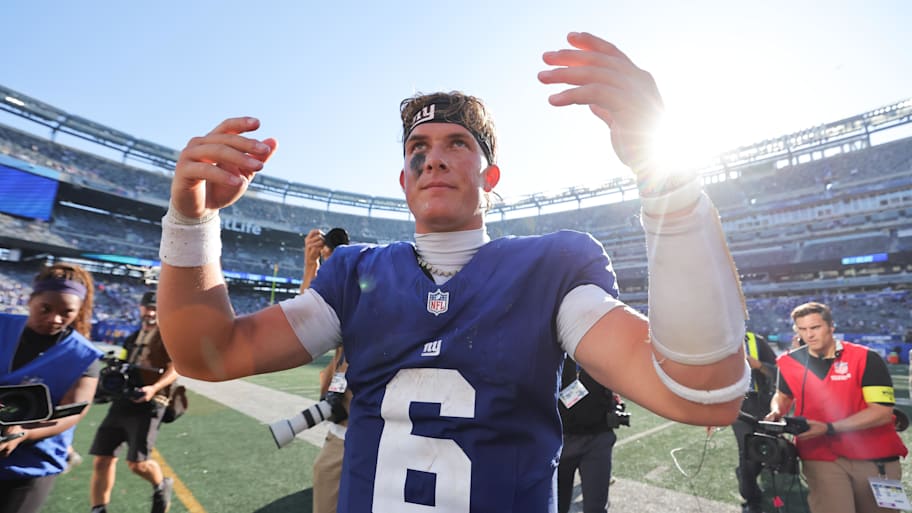 Jackson Dart lifts his arms to celebrate after a win.