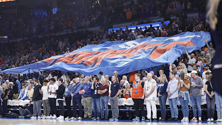 Mar 29, 2024; Oklahoma City, Oklahoma, USA; Oklahoma City Thunder fans pass a giant flag through the crowd before the start of a game against the Phoenix Suns at Paycom Center