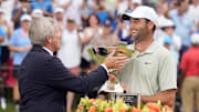 Sep 1, 2024; Atlanta, Georgia, USA; Sep 1, 2024; Atlanta, Georgia, USA; PGA TOUR Commissioner Jay Monahan presents Scottie Scheffler the FedEx Cup after winning the TOUR Championship golf tournament. Mandatory Credit: John David Mercer-Imagn Images