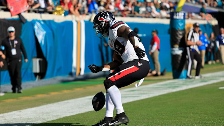 Houston Texans running back Joe Mixon (28) spins the ball before dancing in the endzone celebrating his touchdown score during the third quarter of an NFL football matchup Sunday, Dec. 1, 2024 at EverBank Stadium in Jacksonville, Fla. The Texans held off the Jaguars 23-20. [Corey Perrine/Florida Times-Union]