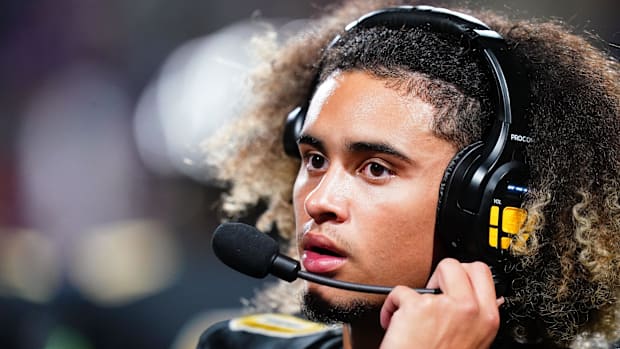 Carrollton Trojans quarterback Julian Lewis (10) watches on from the sidelines against the Westlake Lions during the first ha