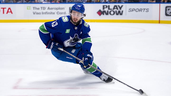 May 20, 2024; Vancouver, British Columbia, CAN; Vancouver Canucks defenseman Quinn Hughes (43) handles the puck against the Edmonton Oilers during the second period in game seven of the second round of the 2024 Stanley Cup Playoffs at Rogers Arena. Mandatory Credit: Bob Frid-Imagn Images