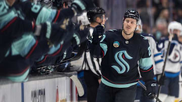 Nov 13, 2025; Seattle, Washington, USA; Seattle Kraken forward Eeli Tolvanen (20) is congratulated by teammates after scoring a goal during the third period against the Winnipeg Jets at Climate Pledge Arena. Mandatory Credit: Stephen Brashear-Imagn Images