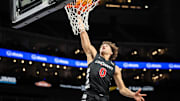 Mar 11, 2025; Kansas City, MO, USA; Cincinnati Bearcats guard Dan Skillings Jr. (0) dunks during the second half against the Oklahoma State Cowboys at T-Mobile Center. Mandatory Credit: William Purnell-Imagn Images