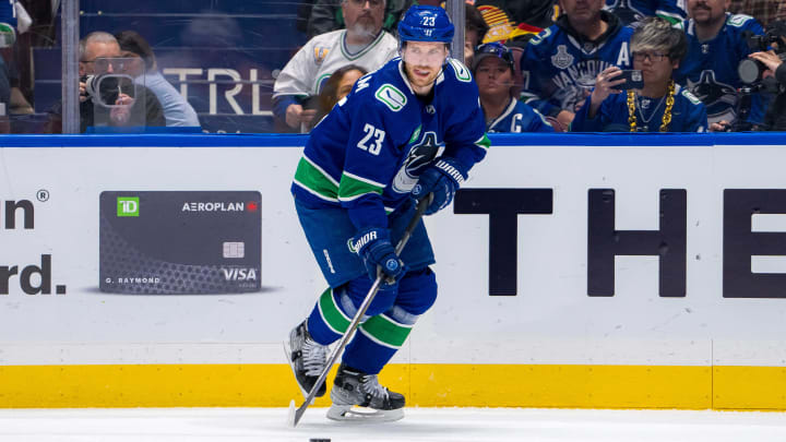 Apr 23, 2024; Vancouver, British Columbia, CAN; Vancouver Canucks forward Elias Lindholm (23) handles the puck against the Nashville Predators during the first period in game two of the first round of the 2024 Stanley Cup Playoffs at Rogers Arena. Mandatory Credit: Bob Frid-USA TODAY Sports