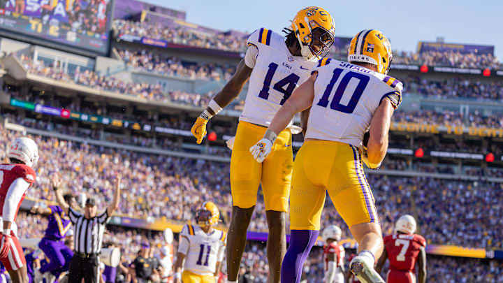 Nov 15, 2025; Baton Rouge, Louisiana, USA;  LSU Tigers tight end Trey'Dez Green (14) celebrates a touchdown by tight end Bauer Sharp (10) against the Arkansas Razorbacks during the second half at Tiger Stadium. Mandatory Credit: Stephen Lew-Imagn Images