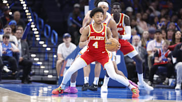 Oct 17, 2024; Oklahoma City, Oklahoma, USA; Atlanta Hawks guard Kobe Bufkin (4) moves the ball around Oklahoma City Thunder forward Ousmane Dieng (13) during the second half at Paycom Center. Mandatory Credit: Alonzo Adams-Imagn Images