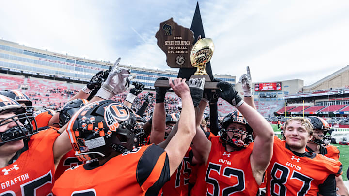 Members of the Grafton High School football team hoist the gold trophy for their fans, after defeating Reedsburg, 17-15, in the WIAA Division 3 state football championship game at Camp Randall Stadium in Madison on Friday, Nov. 21, 2025. Members of the Grafton High School football team hoist the gold trophy for their fans, after defeating Reedsburg, 17-15, in the WIAA Division 3 state football championship game at Camp Randall Stadium in Madison on Friday, Nov. 21, 2025.