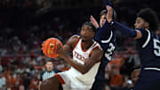 Nov 12, 2025; Austin, Texas, USA; Texas Longhorns guard Tramon Mark (12) drives to the basket against Fairleigh Dickinson center Cyril Martynov (22) and guard Chidube Ekwommadu (5) during the first half at Moody Center. Mandatory Credit: Dustin Safranek-Imagn Images