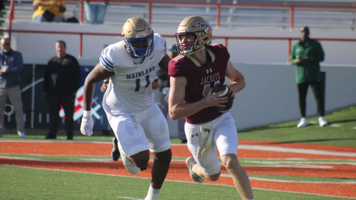 Mainland defensive lineman LJ McCray pursues St. Augustine quarterback Locklan Hewlett during the FHSAA Class 3S high school football championship in Tallahassee on December 7, 2023. [Clayton Freeman/Florida Times-Union]