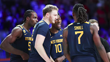 Nov 28, 2024; Paradise Island, Bahamas, BHS;  West Virginia Mountaineers guard Toby Okani (5) and West Virginia Mountaineers guard Sencire Harris (10) and West Virginia Mountaineers guard Tucker DeVries (12) and West Virginia Mountaineers guard Javon Small (7) huddle before the game against the Louisville Cardinals at Imperial Arena at the Atlantis resort.  Mandatory Credit: Kevin Jairaj-Imagn Images