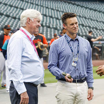 Seattle Mariners center fielder Julio Rodriguez (44) talks with majority owner John Stanton, left, and general manager Jerry Dipoto during batting practice against the Baltimore Orioles at T-Mobile Park in 2022.