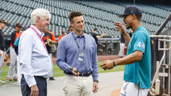 Seattle Mariners center fielder Julio Rodriguez (44) talks with majority owner John Stanton, left, and general manager Jerry Dipoto during batting practice against the Baltimore Orioles at T-Mobile Park in 2022.