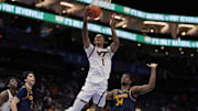 March 11, 2025. Virginia Tech forward Tobi Lawal (1) attempts a layup defended by California forward Lee Dort (34).
