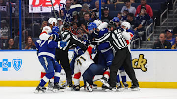 Oct 2, 2025; Tampa, Florida, USA; Florida Panthers center Luke Kunin (71) and Tampa Bay Lightning center Jack Finley (62) lock up in the third period at Benchmark International Arena. Mandatory Credit: Nathan Ray Seebeck-Imagn Images